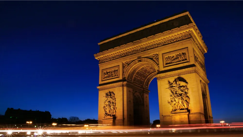 Arc de Triomphe in Paris at night near central arrondissements