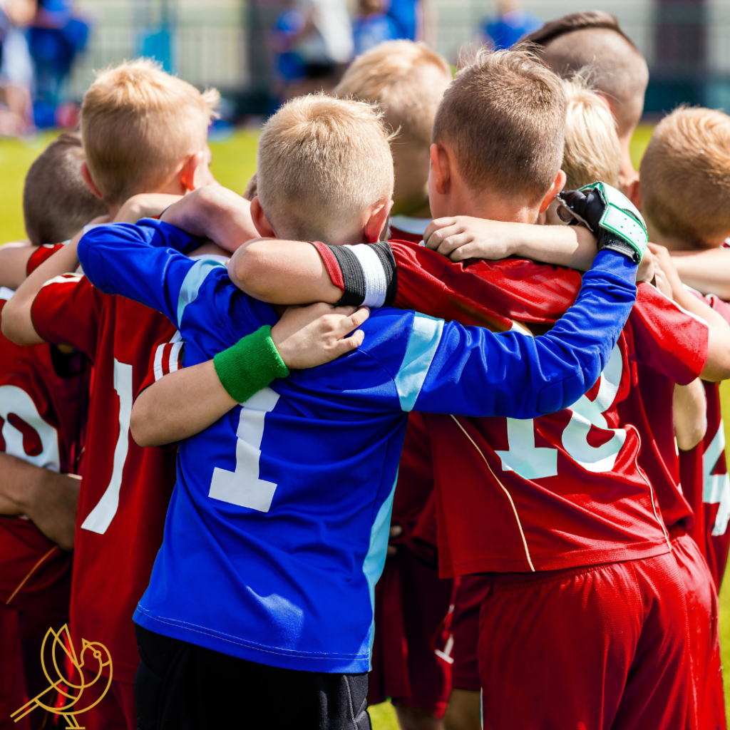 Kids wearing soccer jerseys huddled up during a soccer game, an extracurricular activity parents can sign up for at a forum des associations